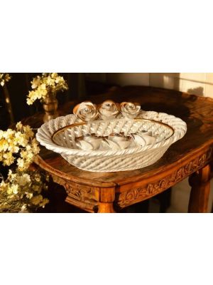 Handcrafted ceramic centerpiece with roses and gold details.