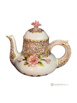 Handmade ceramic teapot in baroque style, decorated with elegant flowers and golden details.